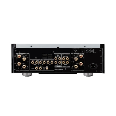 Spatele amplificatorului Yamaha A-S1200, culoare neagră, arată multiple intrări/ieșiri audio și conectori boxe.