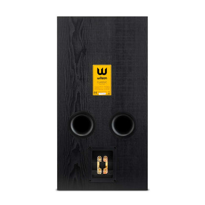 Spatele boxei Wilson Classic Boxe de raft, culoare Black Oak, cu porturi de bass reflex și conectori audio.