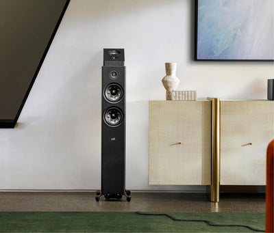 Boxa de podea Polk Audio Reserve R600 neagră, vedere frontală, amplasată într-un living modern. Două difuzoare mari și un tweeter sunt vizibile.