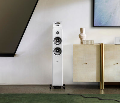 Boxa de podea albă Polk Audio Reserve R600, vedere frontală, amplasată într-un living modern. Două woofere și un tweeter vizibile.